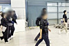 Two suspects of running illegal gambling sites from overseas arrive in Korea via Incheon International Airport on Oct. 14.