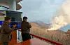 North Korean leader Kim Jong-un, center, inspects a test-firing of hypersonic missile propelled by solid fuel in a photo carried by Rodong Sinmun in 2024.