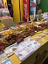 Trays of Korean fried chicken and a multilingual menu at a Mangwon Market stall in Seoul.
