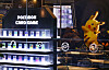 Pokémon trading card displays and a large Pikachu figure inside a Seoul card shop.