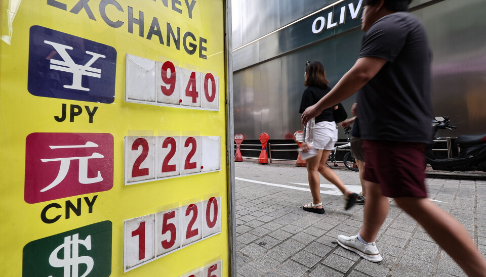 A person walks by a private currency exchange booth in Seoul on July 5.