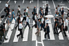 People walk along a pedestrian crossing at a shopping street Wednesday, June 4, 2025, in Tokyo. (AP Photo/Eugene Hoshiko)