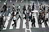People walk along a pedestrian crossing at a shopping street Wednesday, June 4, 2025, in Tokyo. (AP Photo/Eugene Hoshiko)