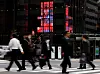 FILE PHOTO: Pedestrians walk past an electronic board displaying various companies' share prices, at a business district in Tokyo, Japan, October 31, 2023. REUTERS/Kim Kyung-Hoon/File Photo/2024-01-10 10:02:07/