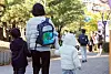 Students and parents wearing winter jackets arrive at an elementary school in Hwaseong, Gyeonggi, on Oct. 22.