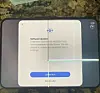 Foldable iPhone Duo showing a software-update prompt and bright lines across its cracked inner screen.