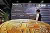 Cryptocurrency prices are displayed on a screen at Bithumb's space in Gangnam District, southern Seoul, on Sept. 22.